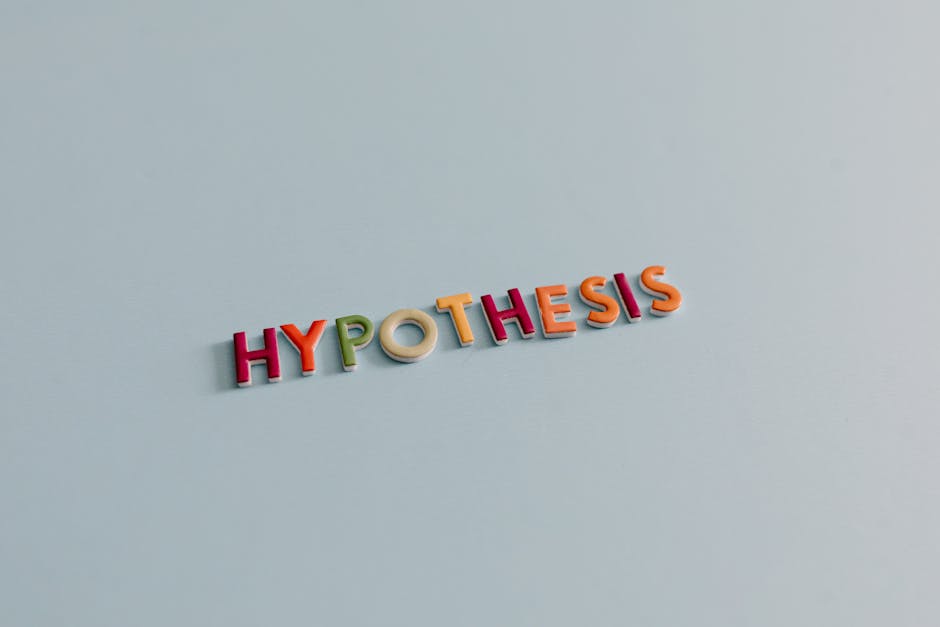 Multicolored letters spell 'HYPOTHESIS' on a light blue surface, conveying research and creativity.