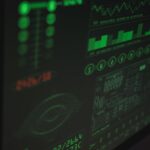 Close-up view of a computer displaying cybersecurity and data protection interfaces in green tones.