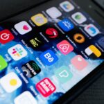 Detailed view of smartphone displaying multiple app icons on screen, highlighting technology use.